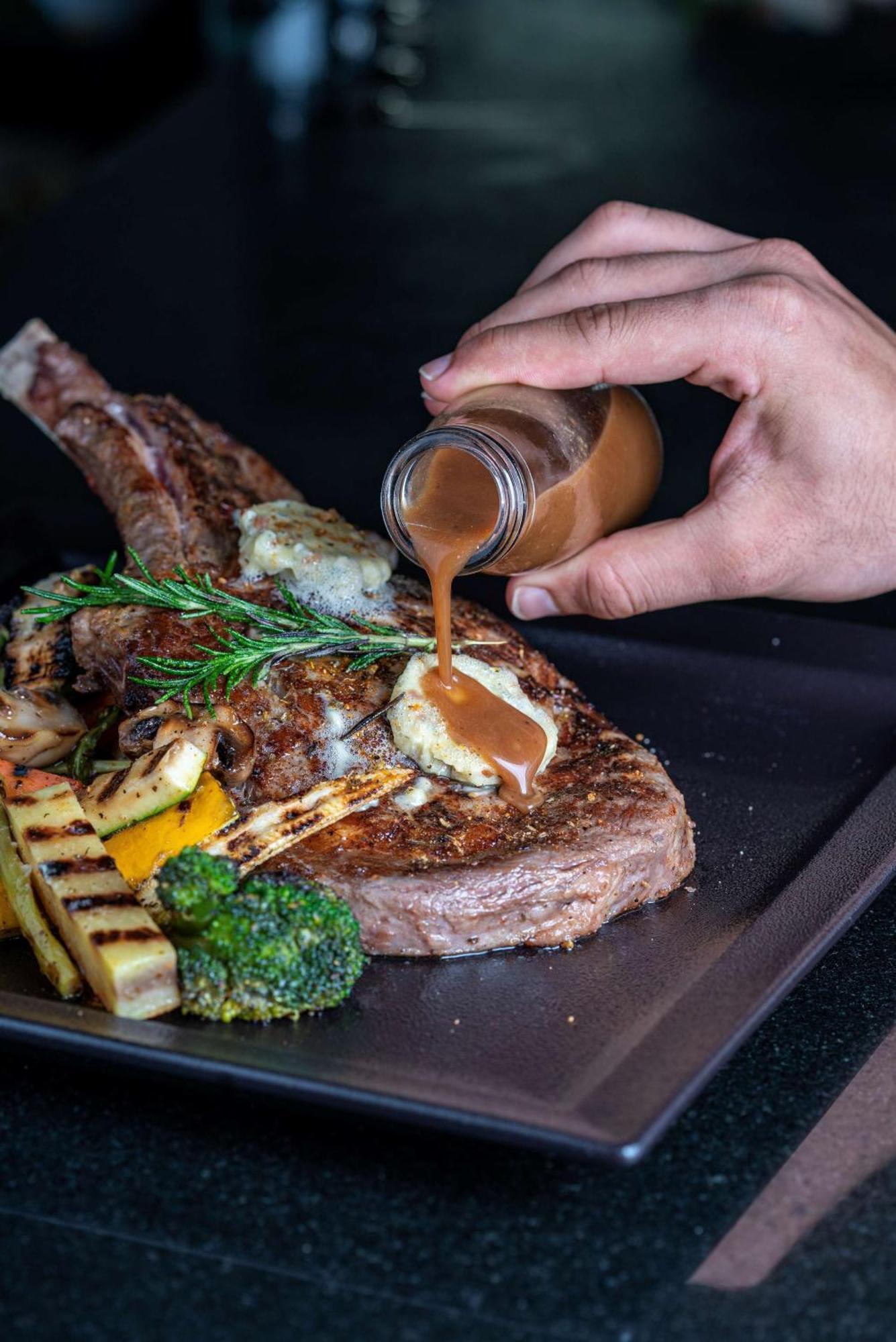 Radisson Blu Hotel & Resort, Sohar Εξωτερικό φωτογραφία A steak being drizzled with a sauce